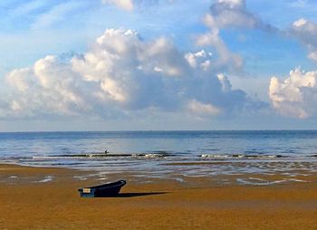 Scenic view of calm beach against sky