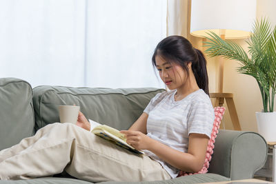 Young woman using laptop at home