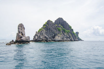 Scenic view of rocks in sea against sky