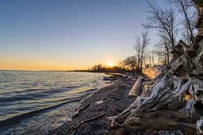 Scenic view of frozen sea against sky during sunset