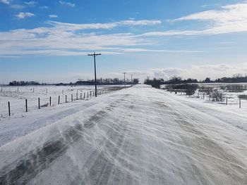 Snow covered landscape against sky