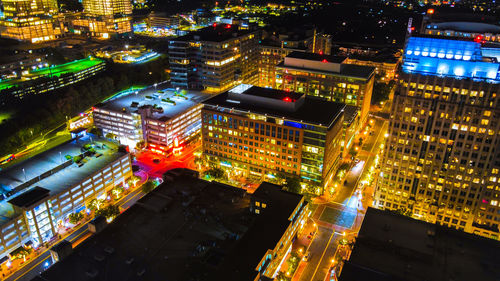 High angle view of city lit up at night