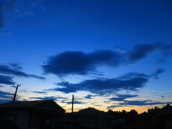 Low angle view of silhouette buildings against sky at sunset