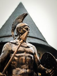 Low angle view of angel statue against sky