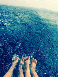 Low section of woman standing on beach