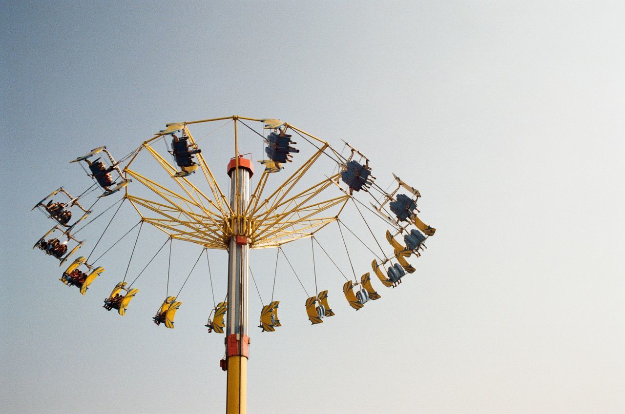 LOW ANGLE VIEW OF CAROUSEL AGAINST SKY