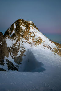 Scenic view of snowcapped mountains against clear sky