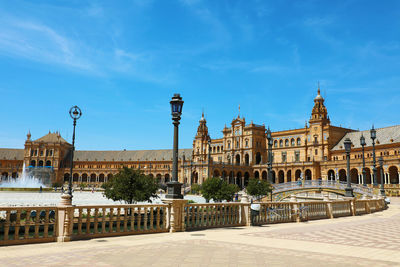 Buildings in city against blue sky