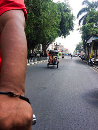 Midsection of man skateboarding on street in city