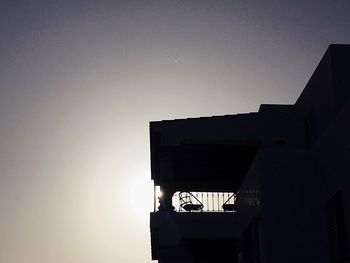 Buildings against clear sky at dusk