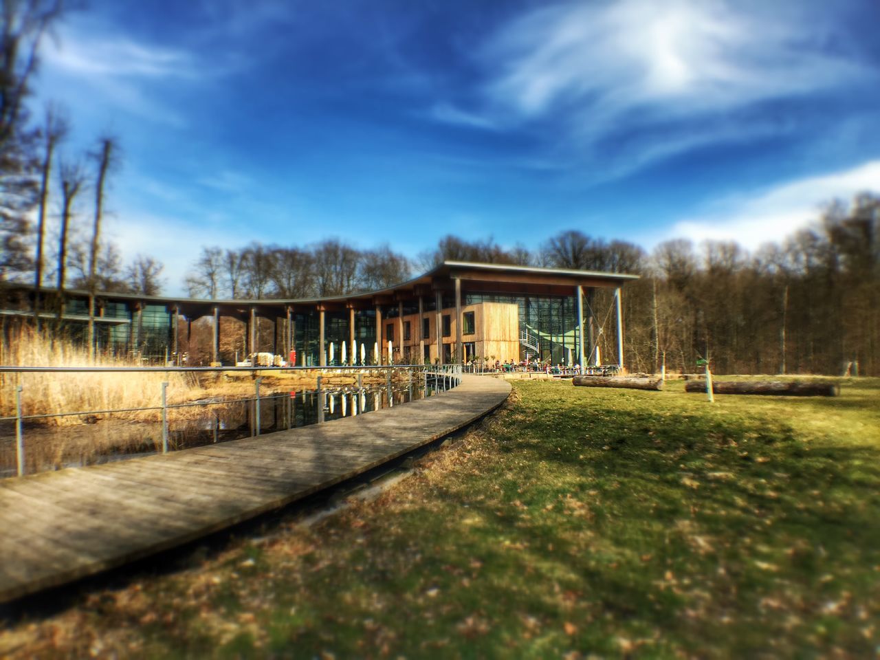 sky, architecture, built structure, cloud - sky, building exterior, tree, grass, cloud, house, day, railing, outdoors, cloudy, sunlight, surface level, nature, no people, empty, incidental people, field