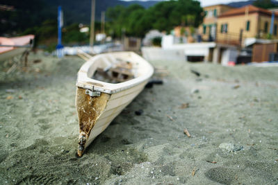 Close-up of abandoned boat on street