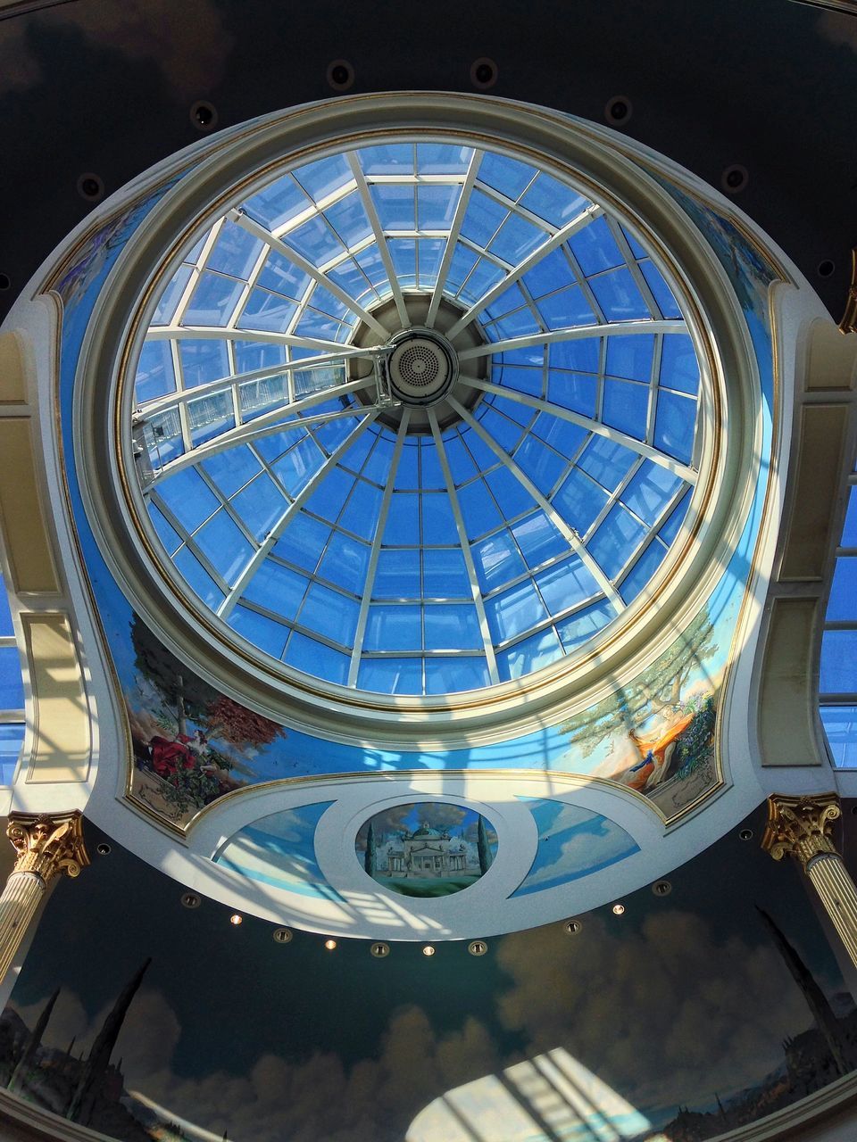 architecture, low angle view, built structure, indoors, ceiling, church, place of worship, dome, religion, building exterior, architectural feature, circle, directly below, spirituality, design, cathedral, pattern, clock, ornate