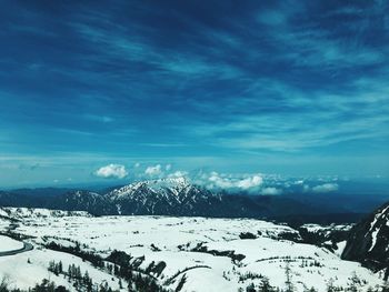 Scenic view of snow covered mountains against sky