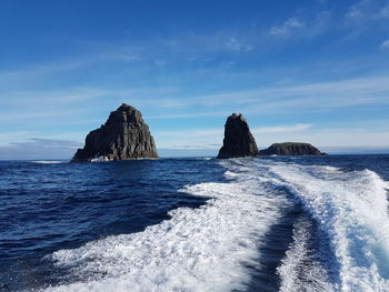 Panoramic view of sea against blue sky