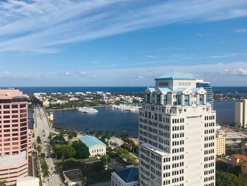 High angle view of buildings by sea against sky