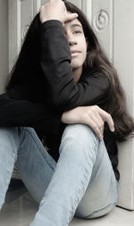 Young woman sitting at home