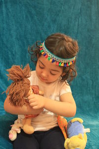 High angle view of cute girl holding toy