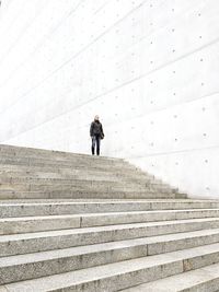 Low angle view of woman standing against sky