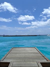 Scenic view of swimming pool by sea against sky