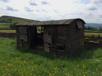 Built structure on field against sky