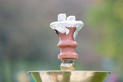 Close-up of cross against blurred background