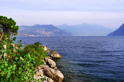 Scenic view of rocks in sea against sky