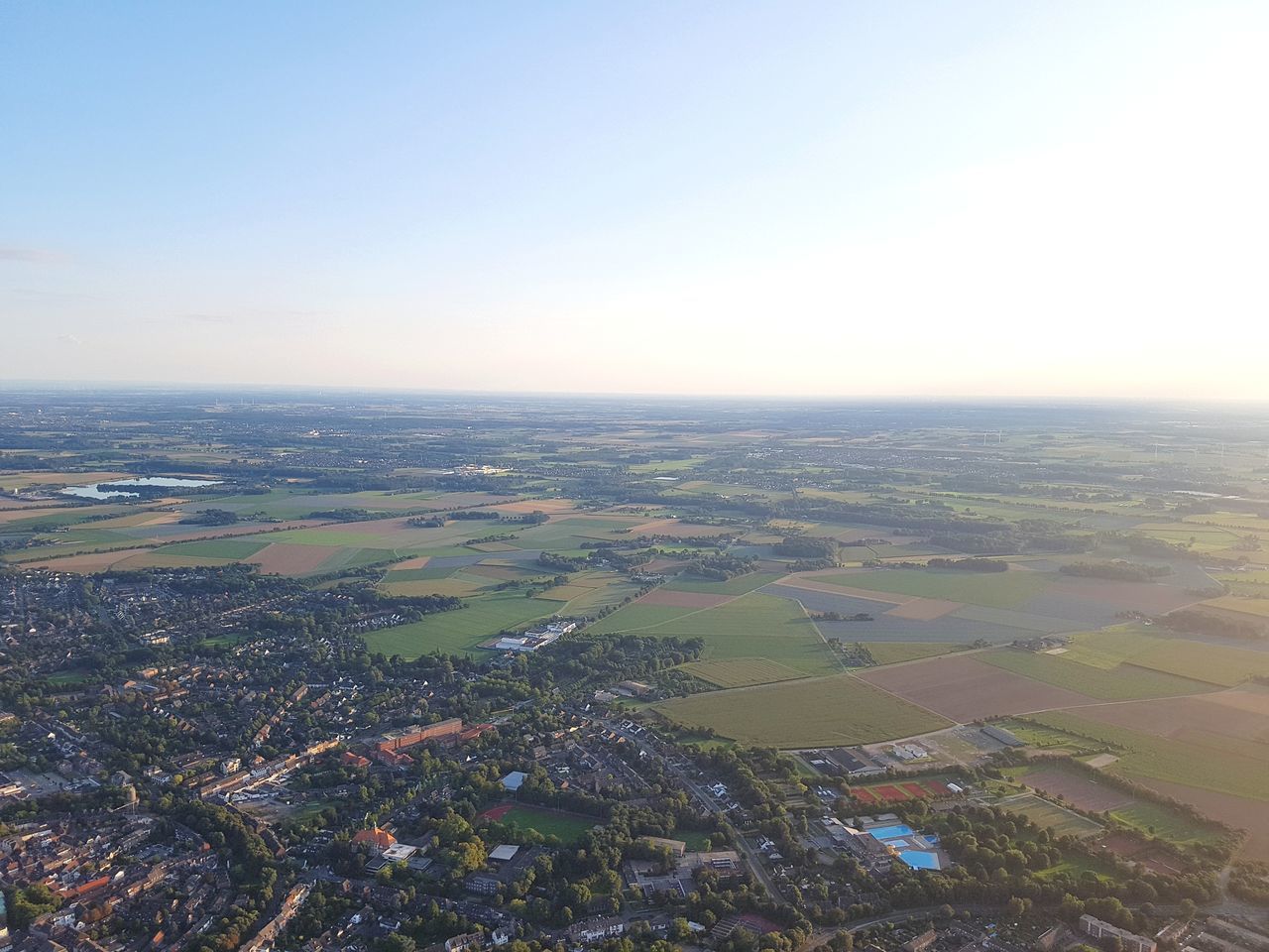 AERIAL VIEW OF AGRICULTURAL LANDSCAPE AGAINST SKY