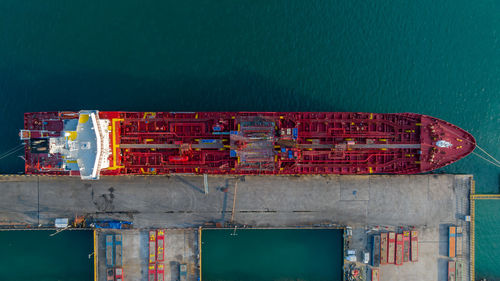 Aerial view crude oil tanker at port, oil tanker loading and unloading in oil terminal station.