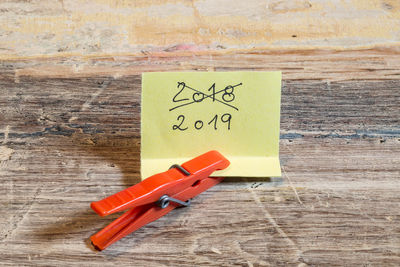 Close-up of clothespin and paper on table