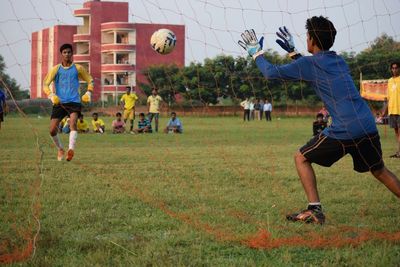 Boy playing soccer on grassy field