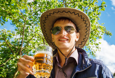 Portrait of smiling man drinking beer