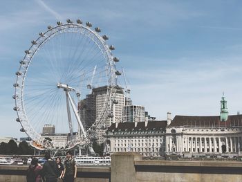 Ferris wheel in city against sky