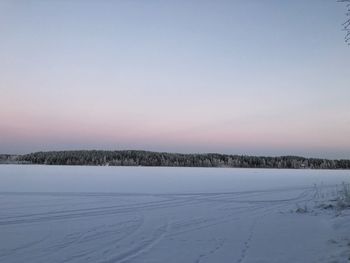 Scenic view of snow covered field against clear sky