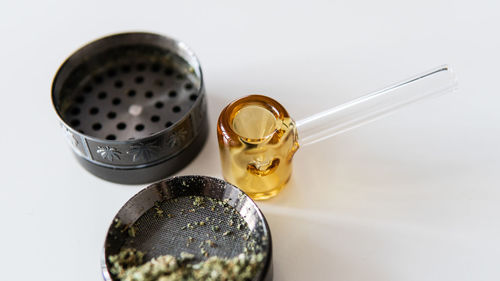 High angle view of drinking glass on table against white background