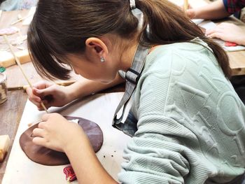 Side view of young woman using digital tablet