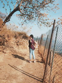 Full length of boy playing on field against sky