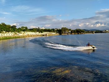 People in jet boat on lake