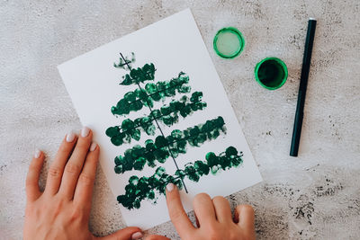 Diy making greeting card handmade crafts on holiday for children. paint with fingers merry christmas 