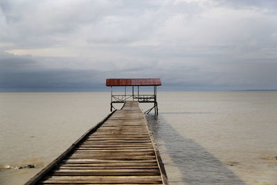 Lifeguard hut on beach against sky