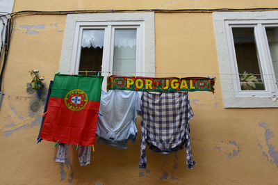 Low angle view of clothes drying against building