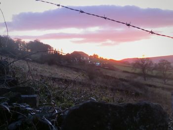 Scenic view of field against sky during sunset