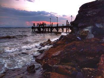 View of bridge over sea against cloudy sky
