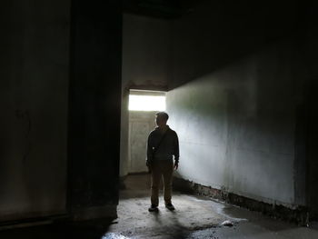 Full length of man standing in abandoned house