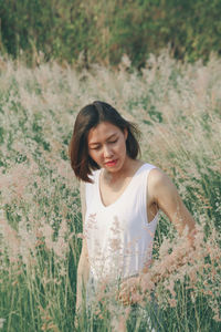 Young woman standing on field