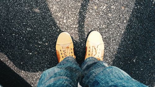 Low section of person standing on tiled floor