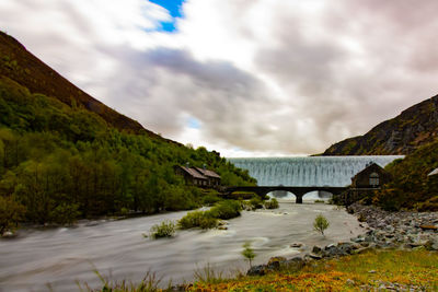 Bridge over mountain against sky