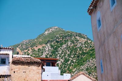 Low angle view of buildings against clear blue sky