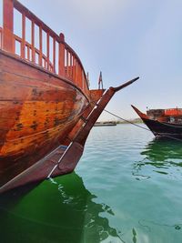 Boat moored on sea against clear sky