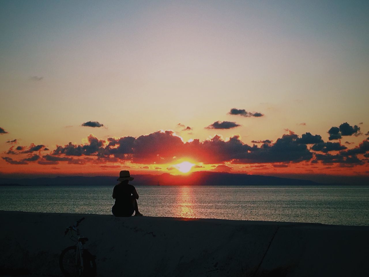 sunset, sea, horizon over water, silhouette, water, scenics, orange color, sun, beauty in nature, tranquil scene, tranquility, sky, idyllic, nature, beach, standing, remote, men